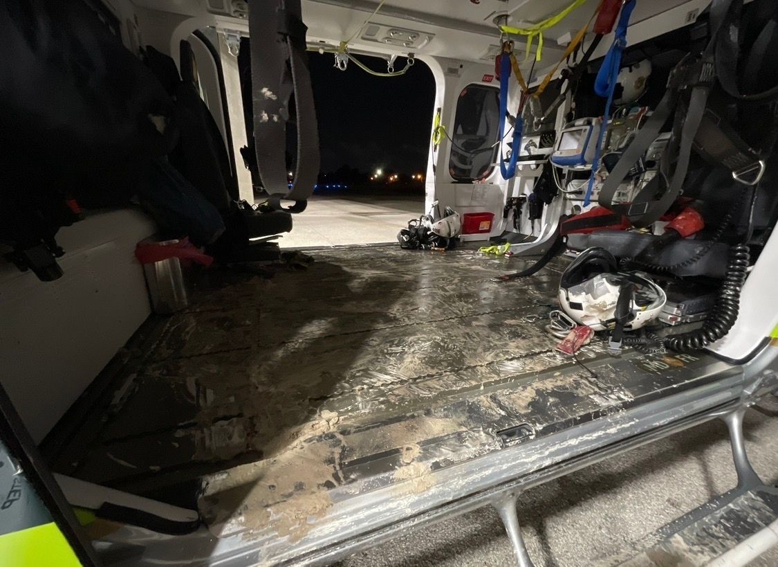 the inside messy interior of a rescue helicopter full of mud and dirt after a search and rescue hoist mission